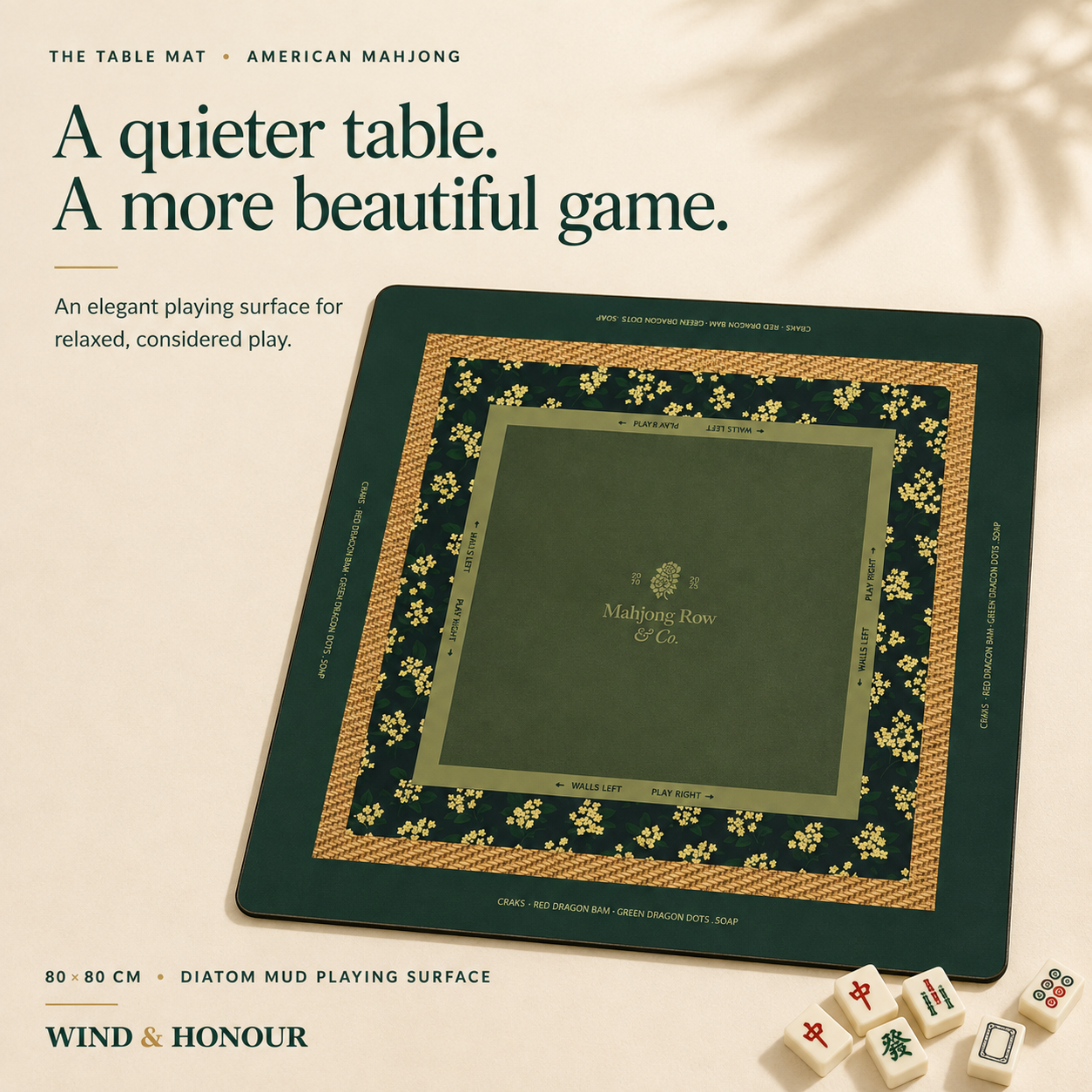 Green square Mahjong table mat with floral border and four loose tiles