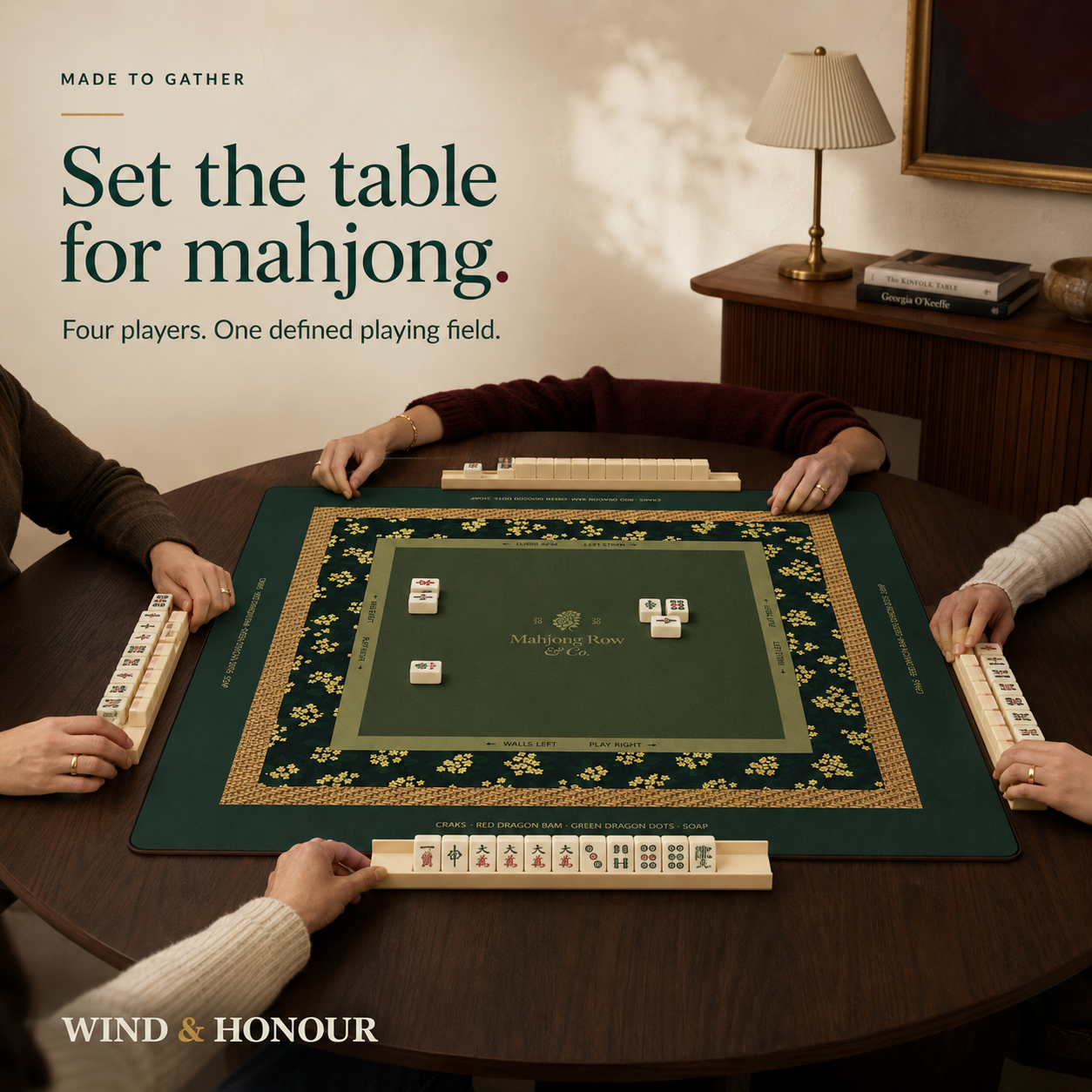Four people playing Mahjong on the green table mat
